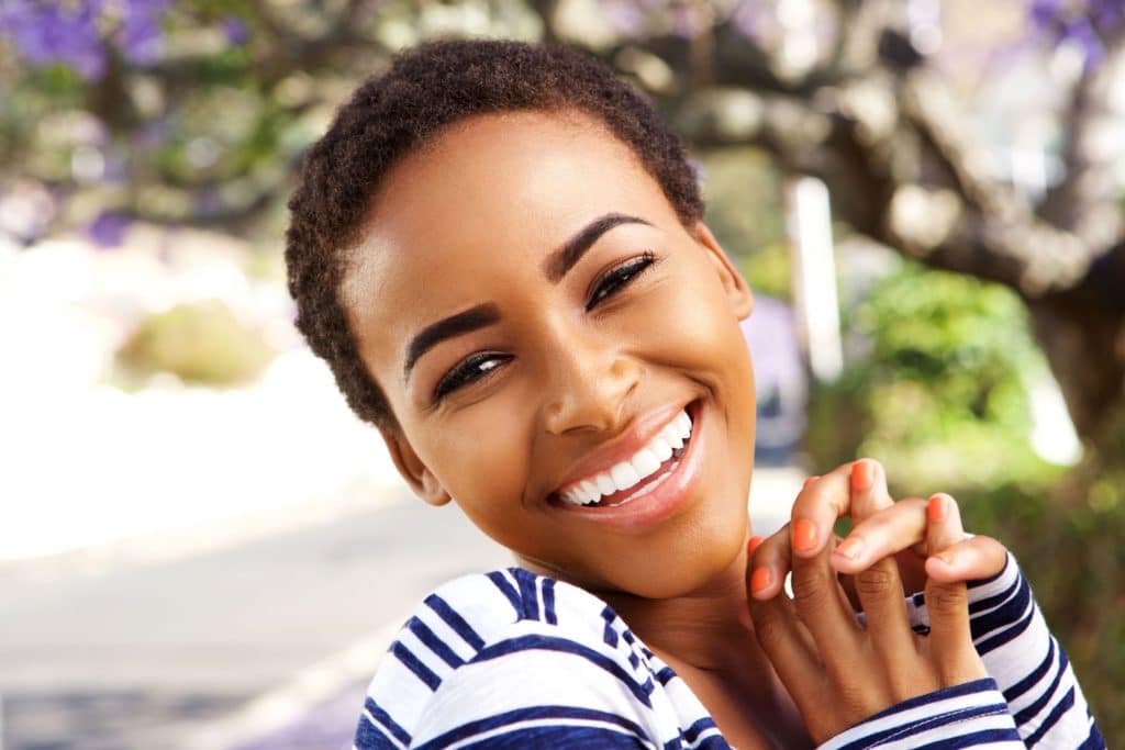 Elegant young woman in striped shirt smiling