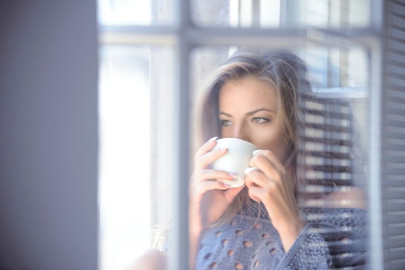 Calm woman with tootache drinking soothing peppermint tea