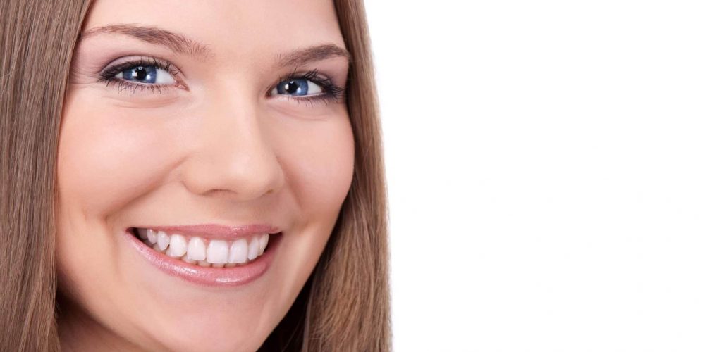Beautiful woman smiling with white fillings